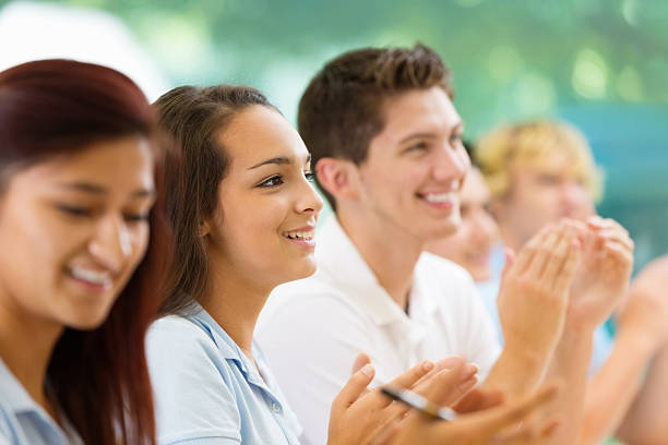 istock Teen students applauding during lecture at private school 462576513