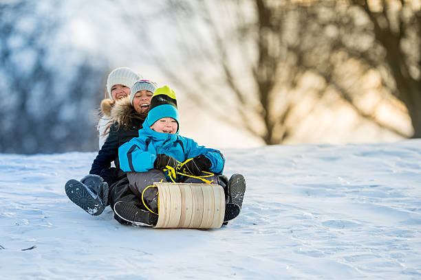 winterspaß auf tobbogan hill - schlittenfahren stock-fotos und bilder