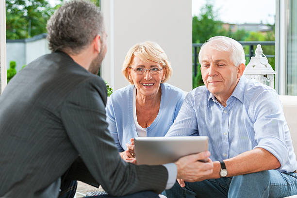 istock Senior couple talking with financial advisor 462579191