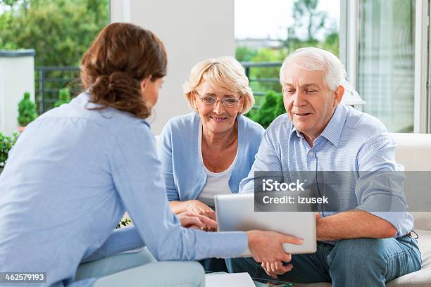 Senior Couple Talking With Insurance Agent Stock Photo - Download Image Now - Senior Adult, Financial Advisor, Medical Insurance