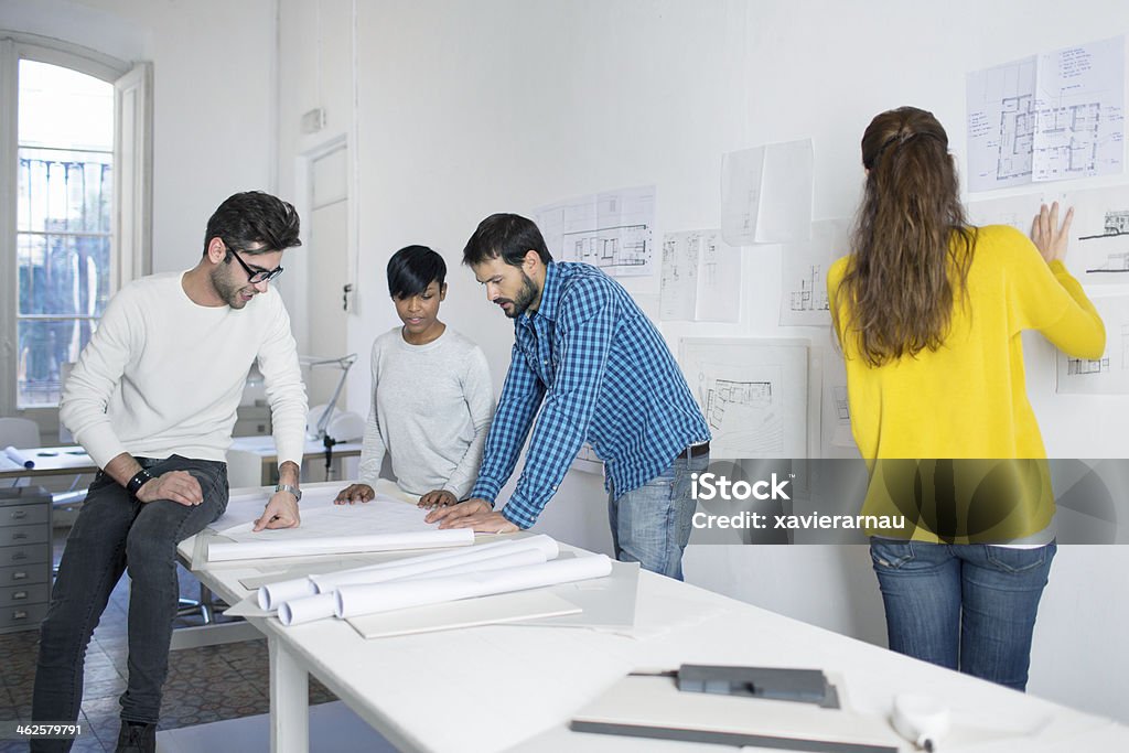Architect's working day Four people working in an architecture office. Adult Stock Photo