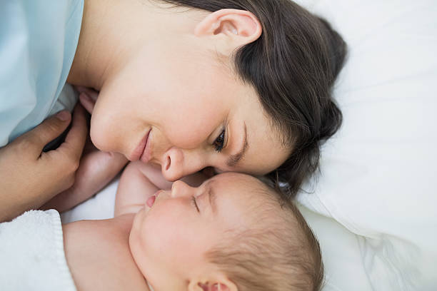 istock Mother looking at her sleeping baby 462580637