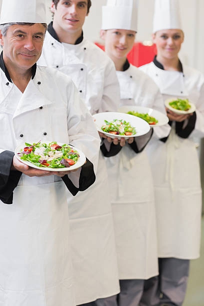 istock Chefs presenting their bowls of salad 462581303
