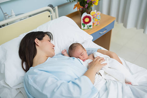 istock Mother and newborn baby sleeping in the same bed 462582625