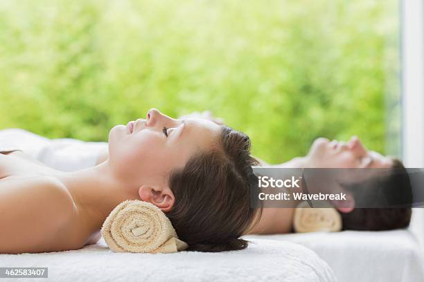 Couple Sleeping On Massage Tables Stock Photo - Download Image Now - 20-29 Years, Adult, Brown Hair