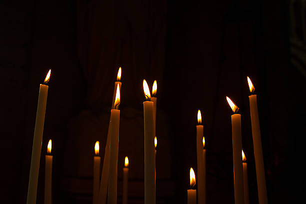 istock Wax candles lit in a church 462585969