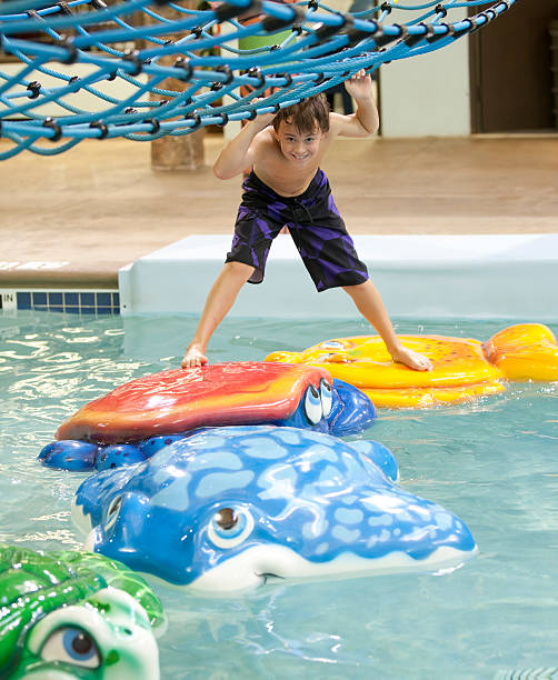 istock Young boy playing at the indoor water park 462587031