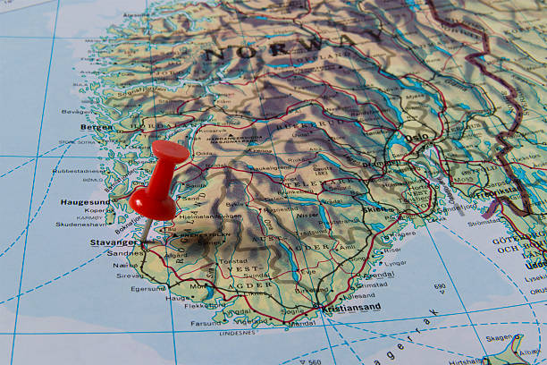 Stavanger Marked with Red Pushpin on Norway Map Stavanger marked with red pushpin on map. Selected focus on Stavanger and bright red puspin. Pushpin is in an angle. Southern parts of Norway can be seen on map. green map of norway stock pictures, royalty-free photos & images