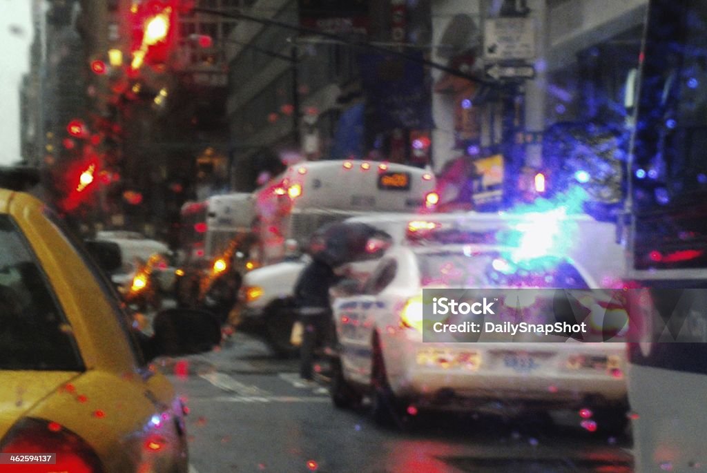 New York City in Hot Persuit New York City, NY near Times Square with the New York Police Department aka NYPD in hot pursuit, On a Cold Wet Day in December, Slowing a New York City Bus and a Yellow Taxi Cab. Police Force Stock Photo