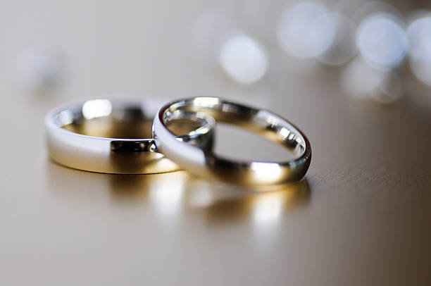 Golden wedding rings Wedding rings shot in soft focus civil partnership stock pictures, royalty-free photos & images