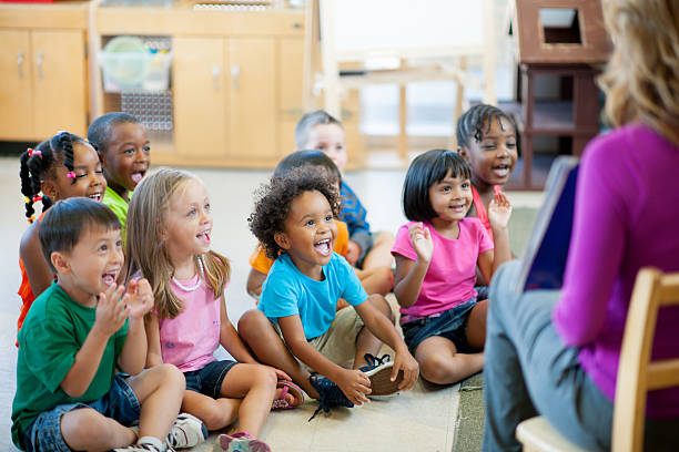 Pre-schoolers in classroom Multi ethnic group of pre-school children in a classroom. preschool student stock pictures, royalty-free photos & images