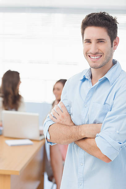 istock Handsome designer standing with arms crossed 462603035