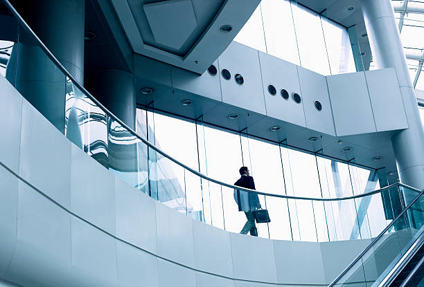 istock Distant businessman walking in a modern office building 462604479