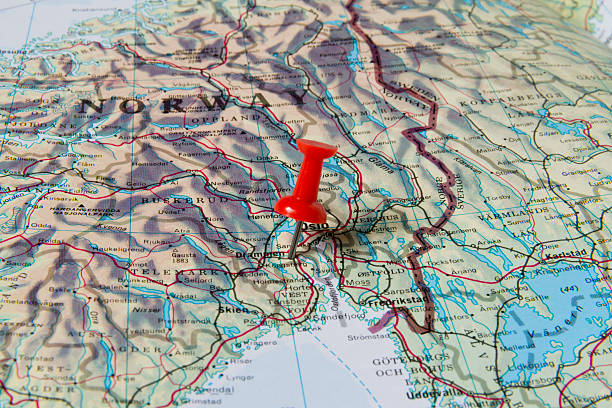 Drammen Marked with Red Pushpin on Norway Map Drammen marked with red pushpin on map. Selected focus on Drammen and bright red puspin. Pushpin is in an angle. Southern parts of Norway can be seen on map. green map of norway stock pictures, royalty-free photos & images