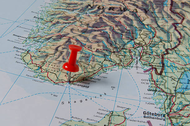 Kristiansand Marked with Red Pushpin on Norway Map Kristiansand marked with red pushpin on map. Selected focus on Kristiansand and bright red puspin. Pushpin is in an angle. Southern parts of Norway can be seen on map. green map of norway stock pictures, royalty-free photos & images