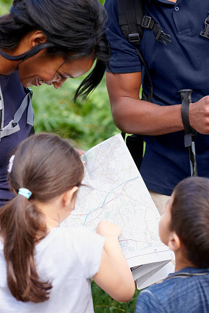 istock Family looking for the way on a map 462613313
