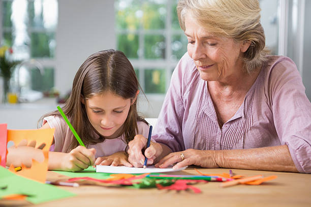 istock Grandmother and granddaughter using a coloured pens 462614091