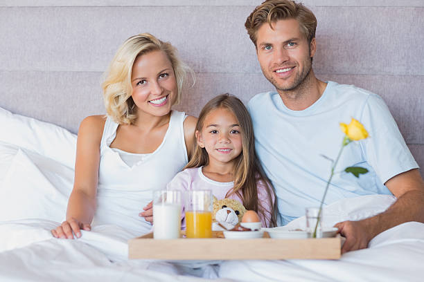 istock Smiling  family taking breakfast in bed 462617453