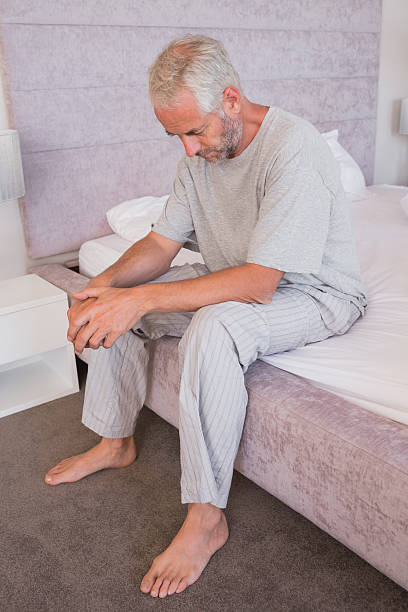 istock Mature man sitting on his bed waking up 462617695