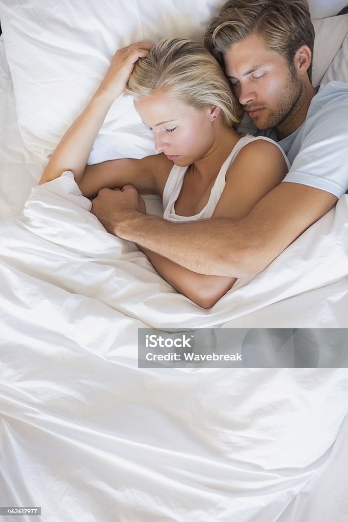 Coppia di dormire nel letto - Foto stock royalty-free di Abbracciare una persona