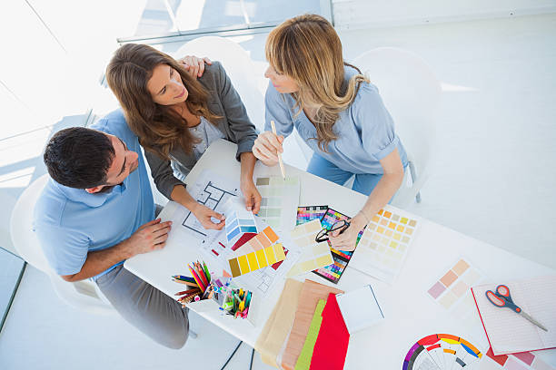 Overview of couple discussing with an interior designer