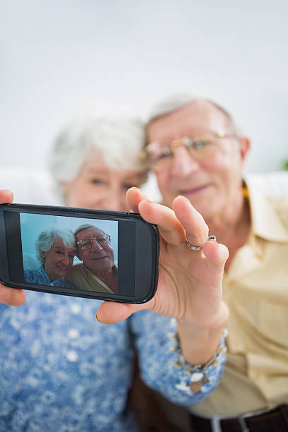 istock Old couple taking pictures together 462618277