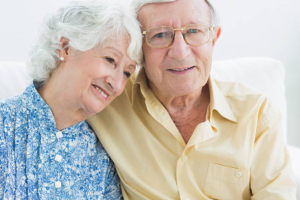 istock Smiling aged couple sitting together 462618345