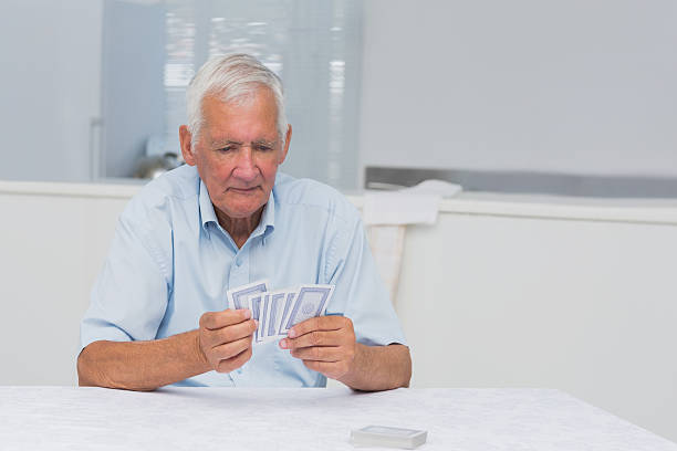 istock Elderly man holding cards 462618453