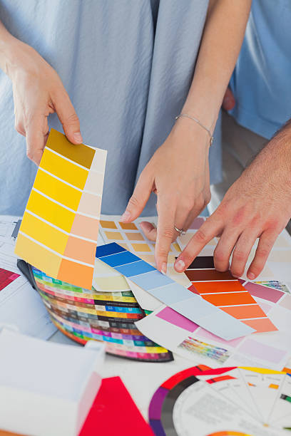 istock Hands of Interior designers pointing at colour charts 462618993