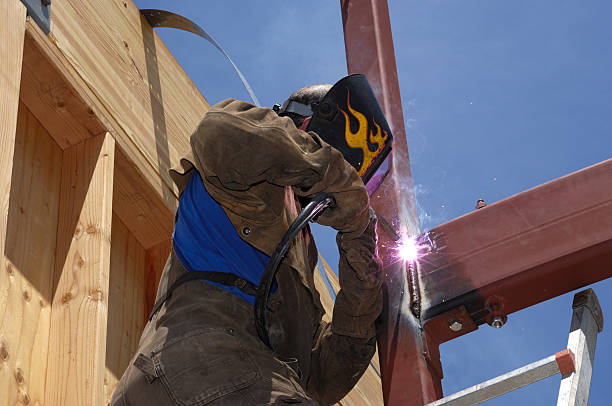 man welding steel in workshop