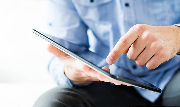 istock Close up of man hands using digital tablet 462631563