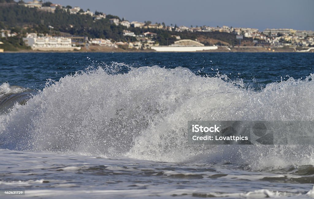 Portrait of a wave breaking in the ocean A huge wave breaking on a holiday beach somewhere exotic. The main focus is on the breaking wave in the foreground, No filters were used on this file, Beach Stock Photo
