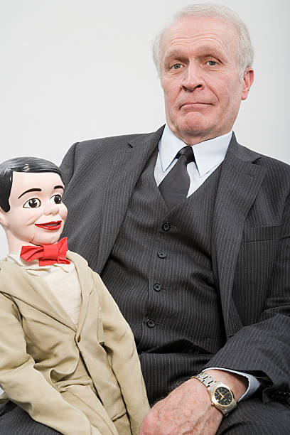 istock Businessman holding a ventiloquists dummy 462633459