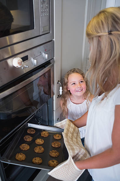 istock Mother and daughter baking cookies 462634153