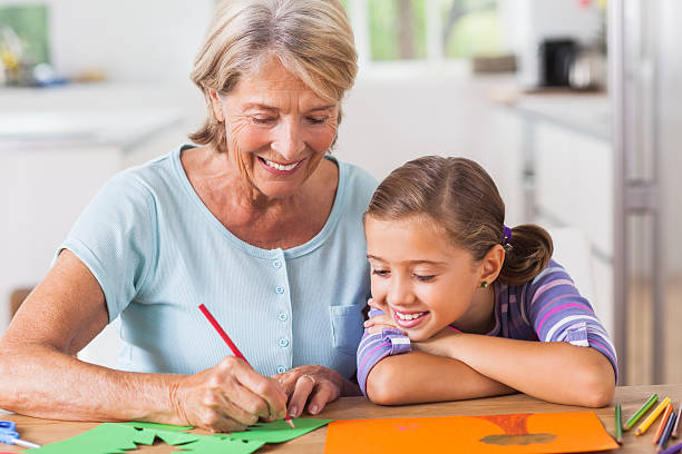 istock Granny and little girl drawing 462634213