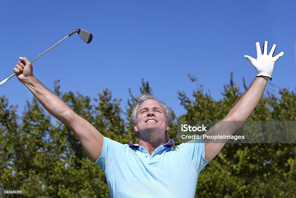 Victory is sweet Shot of a mature male golfer with his arms raised in celebration 50-59 Years Stock Photo