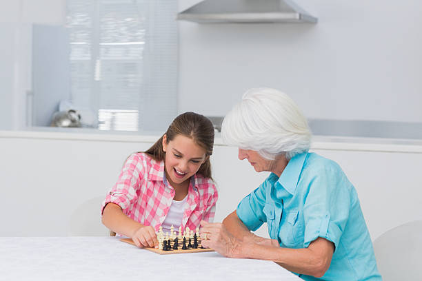 istock Girl and her grandmother playing chess 462637241