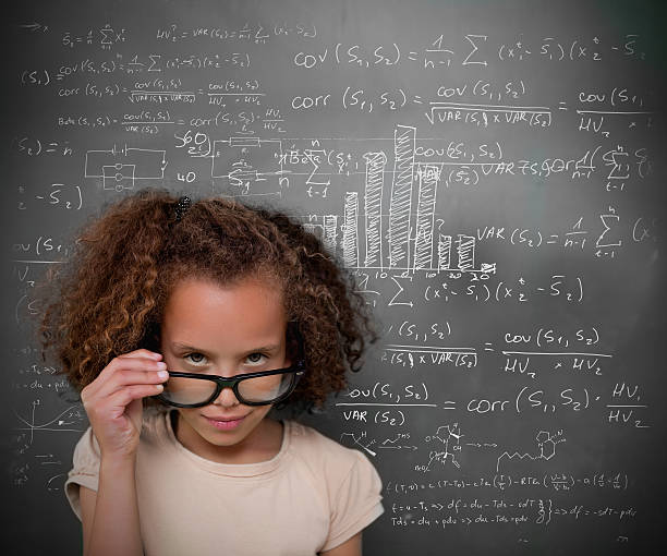 istock Brunette girl looking at camera in front of a blackboard 462641121