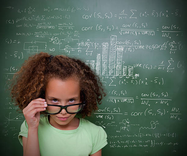 istock Calm girl looking at camera in front of a blackboard 462641143
