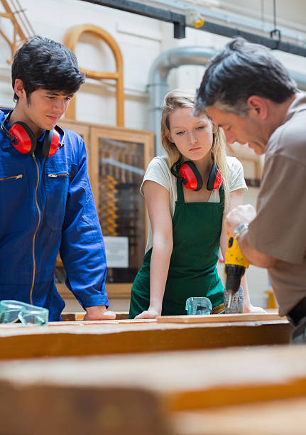 istock Teacher showing how to use a drill 462641957
