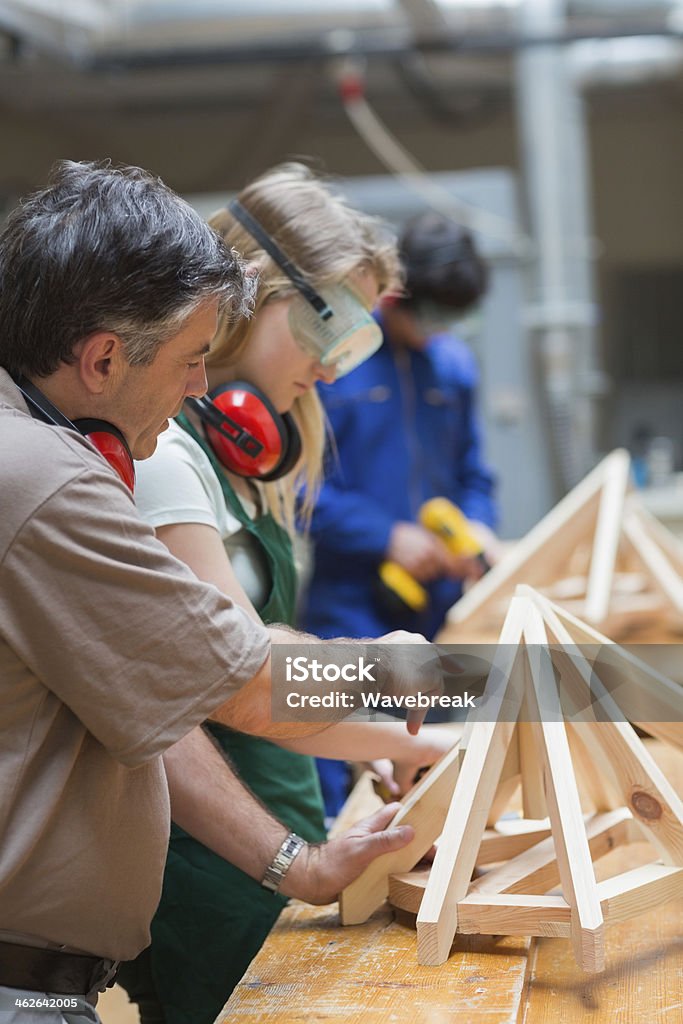 Students in woodwork class building a frame Students of a woodwork class standing while learning how to construct a frame 20-29 Years Stock Photo