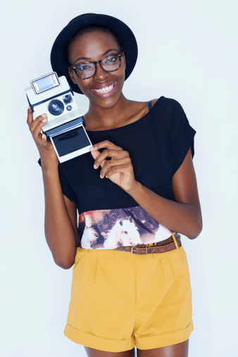 Portrait of a funky young ethnic woman holding a camera