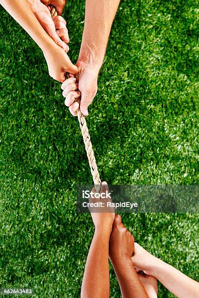 Many Mixed Hands Take Part In Tug Of War Stock Photo - Download Image Now - Tug-of-war, Arguing, Beat The Clock