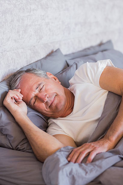 istock Smiling mature man sleeping in his bed 462644705