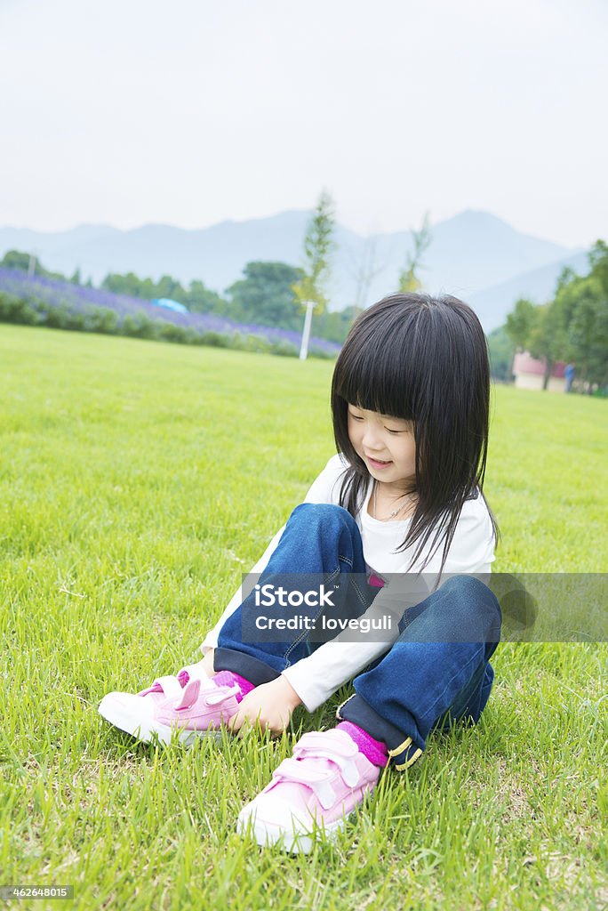 Kleines Mädchen sitzen auf der Wiese, Schnürschuhe - Lizenzfrei Asiatischer und Indischer Abstammung Stock-Foto
