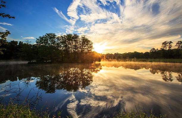 istock Sunrise clouds reflection and mist on a lake 462648379