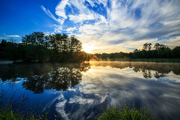istock Sunrise clouds reflection and mist on a lake 462648863