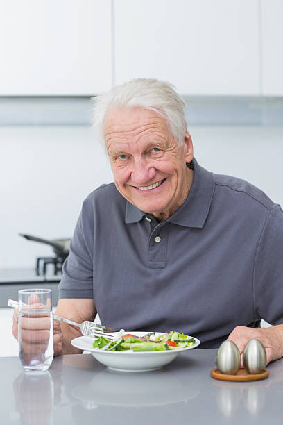 istock Smiling mature man eating salad 462648953