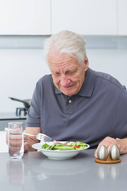 istock Mature man eating salad 462648965