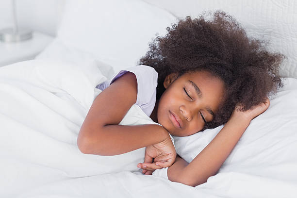 istock Peaceful little girl sleeping in bed 462649197